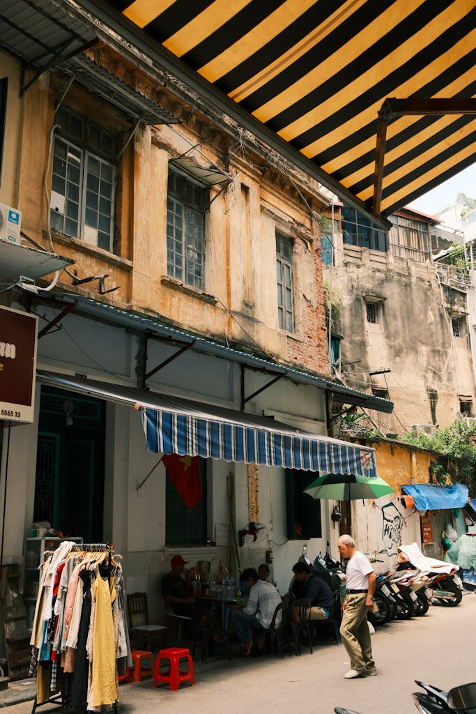 Charming street scene in a historic metro manila alley with locals and colorful awnings.